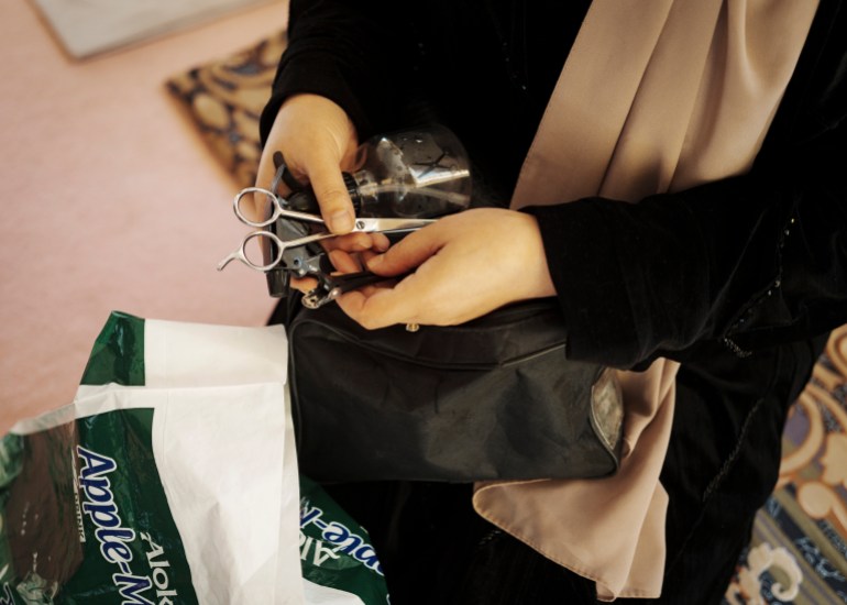 Beauticians carry supplies and equipment under their burqas or in shopping bags to fool the Taliban into thinking they've been to the grocery store [Sandra Calligaro/Al Jazeera]