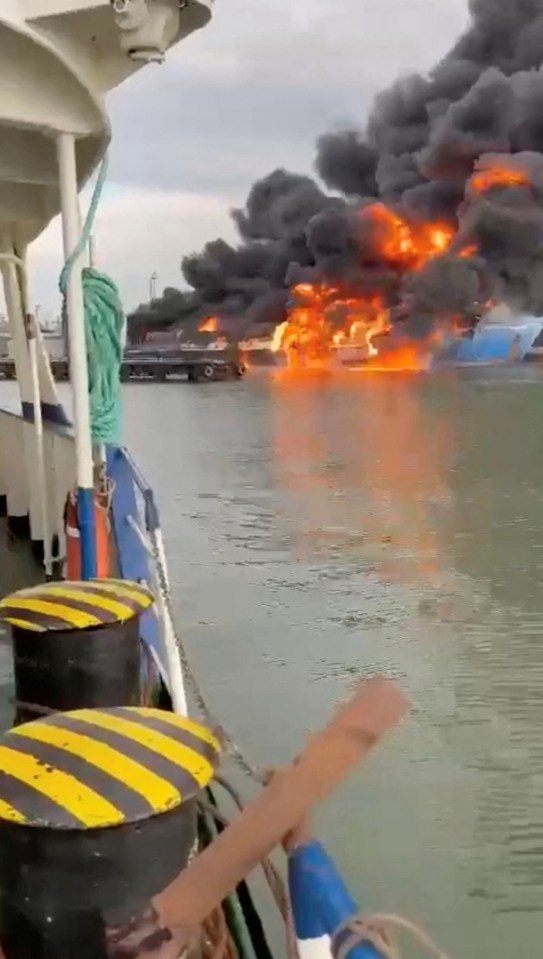 Smoke and flames rise from a ferry following a fire at the port of Kavkaz, in the course of Russia-Ukraine conflict, as seen from Chushka, Krasnodar region, Russia