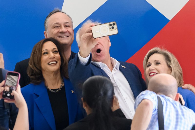 Vice President and presidential hopeful Kamala Harris, along with her running mate Tim Walz and their spouses poses, for a selfie at Wright Brothers Aero, Inc. on Sunday in Pittsburgh. Photo by Archie Carpenter/UPI.