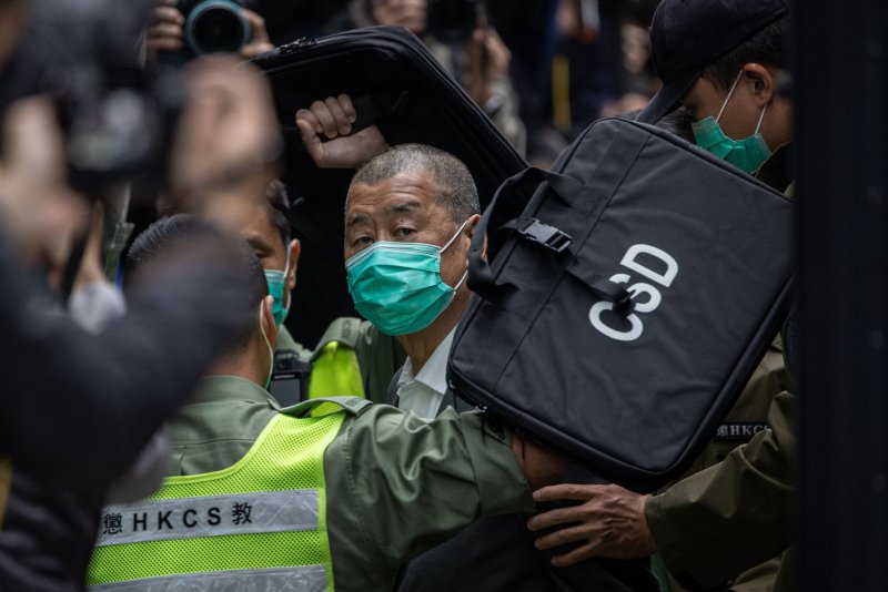 Media mogul Jimmy Lai (C) is escorted out of a Correctional Services Department vehicle and into the Court of Final Appeal in Hong Kong, China, in February 2021. On Monday, Hong Kong's final appeals court dismissed an appeal filed by Lai and six other pro-democracy protests seeking to dismiss their conviction in connection to the mass pro-democracy protest of Aug. 18, 2019. Photo by Jerome Favre/EPA-EFE