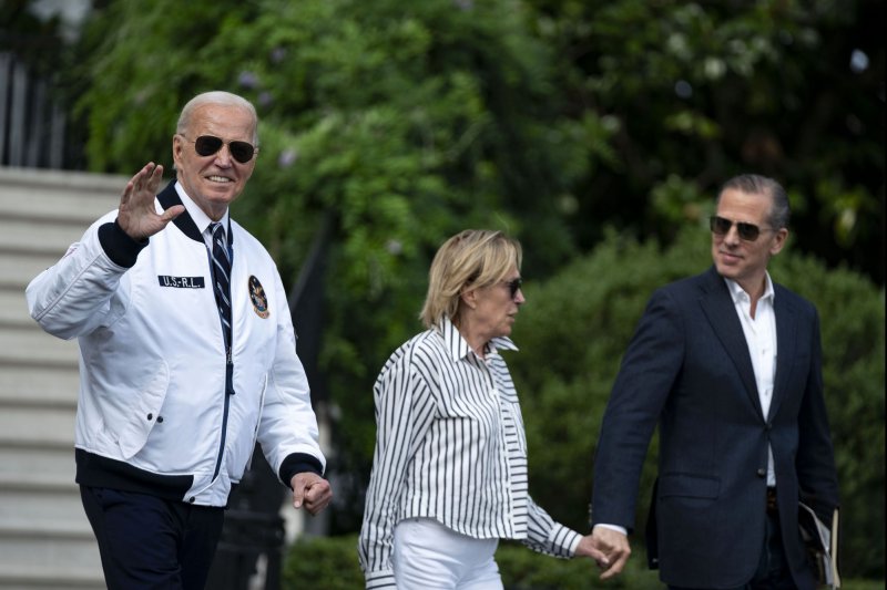 President Joe Biden walks with Valerie Biden Owens and Hunter Biden to board Marine One en route to Camp David at the White House on July 26. The House GOP tied Hunter Biden's business dealings to Joe Biden's impeachment report on Monday. Photo by Bonnie Cash/UPI