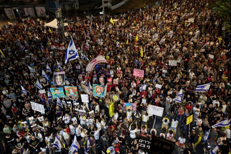 Israelis take part in a protest calling for the immediate release of the Israeli hostages held by Hamas in Gaza, next to the Kirya in Tel Aviv, Israel, on Saturday night. Photo by Atef Safadfi/EPA-EFE/