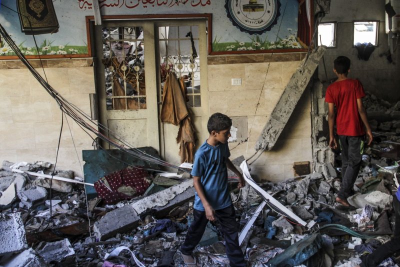 Palestinians search for victims following an Israeli strike that killed more than 100 people in a school sheltering displaced Palestinians. a medical source said, in Gaza City, on Saturday on August 10, 2024. Photo by Mahmoud Zaki/UPI