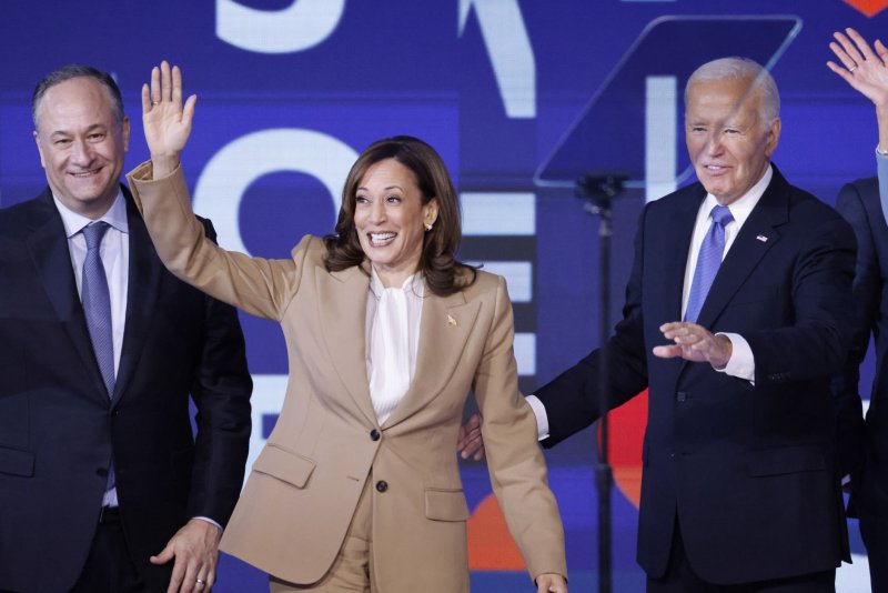 President Joe Biden, Democratic presidential candidate Vice President Kamala Harris and Second Gentleman Doug Emhoff stand on stage after Biden delivered an address at the 2024 Democratic National Convention at the United Center in Chicago, Illinois on Monday. Photo by Tannen Maury/UPI