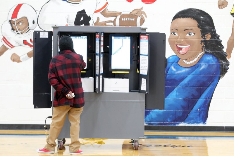 Georgia's new election rules, which aim to increase confidence in the process, have raised concerns of voter suppression. A voter seen here marks his ballot at a polling location at the Dunbar Neighborhood Center in January 2021. File Photo by Tami Chappell/UPI