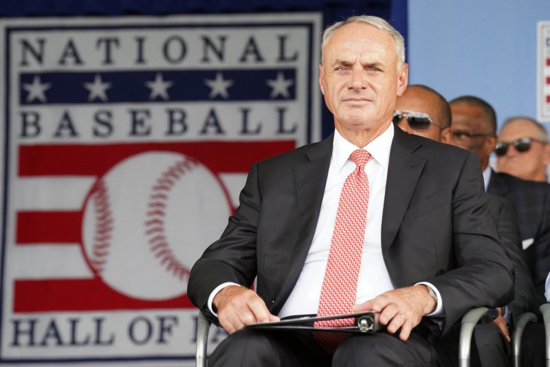 Major League Baseball Commissioner Rob Manfred sits on stage during National Baseball Hall of Fame induction ceremonies in Cooperstown, N.Y., on July 23, 2023. On Aug. 14, 2014, Major League Baseball owners chose Manfred to succeed longtime MLB Commissioner Bud Selig. File Photo by Bill Greenblatt/UPI