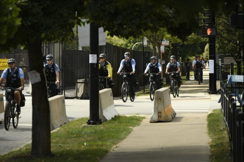 Chicago Police Officers ride by new fencing and cameras outside The United Center during the 2024 Democratic National Convention in Chicago on Tuesday. Photo by Paul Beaty/UPI