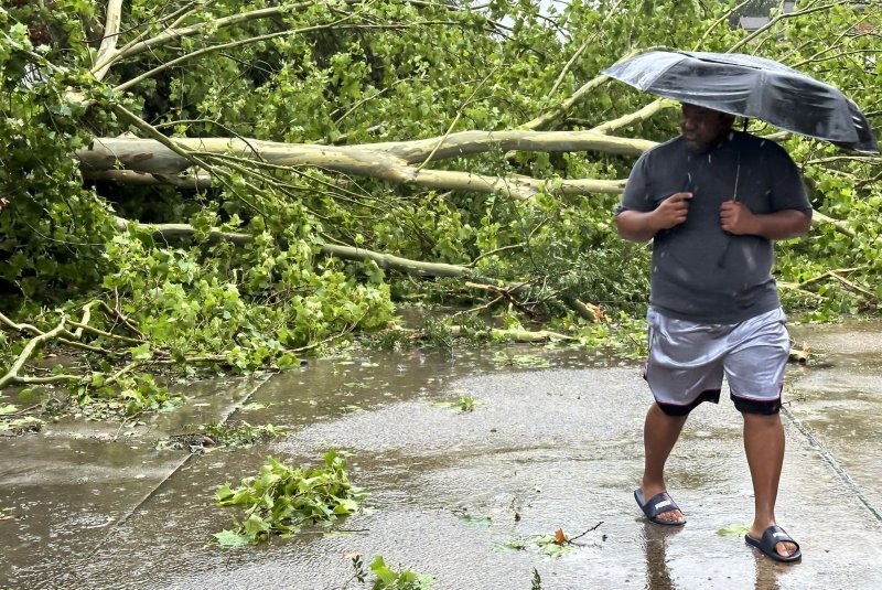 A man looks at a fallen tree knocked over by wind and rain from Hurricane Beryl in Houston, Texas, on July 8. On Wednesday, the U.S. Department of Housing and Urban Development announced $3.6 million in funding for "displaced survivors" from the storm. File Photo by Carlos Ramirez/EPA-EFE