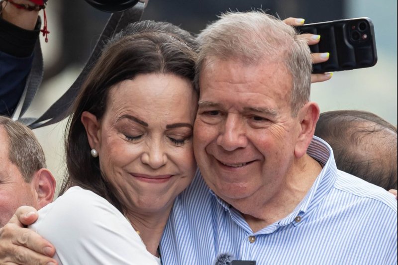 Venezuelan opposition leader Maria Corina Machado (L) hugs Venezuelan presidential candidate Edmundo Gonzalez Urrutia at a rally in Caracas, Venezuela, on Tuesday. On Monday, the attorney general announced they were under investigation over asking the military and police to join them and end their repression of civil society. Photo by Ronald Pena R/EPA-EFE