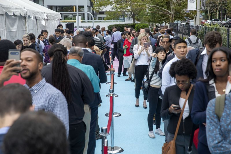 Thousands of jobseekers stand in line at Amazon's future headquarters at a "career day" in Crystal City, Virginia on September 17, 2019. The Labor Department said on Thursday that those filing weekly unemployment claims for the first time increased by 4,000 last week. File Photo by Tasos Katopodis/UPI