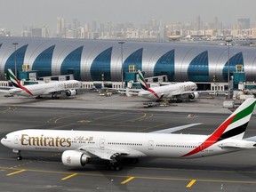 FILE - An Emirates plane taxis to a gate at Dubai International Airport at Dubai International Airport in Dubai, United Arab Emirates, March 22, 2017.