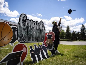 The high cost of living and expensive post-secondary tuition are making students more practical with how they plan for a gap year ahead of the next chapter, experts say. Junior Ittusardjuat, 19, throws his mortarboard in the air as he poses for photos after graduating at Gloucester High School in Ottawa, Wednesday, June 23, 2021.