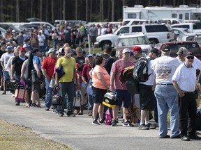 FILE - Hundreds of race fans wait in line to purchase tickets at the Ace Speedway in the rural Alamance County community of Altamahaw near Elon, N.C., on May 23, 2020.