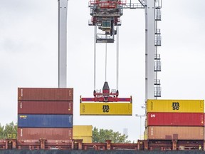 Shippers and producers are holding their breath ahead of a possible strike by thousands of rail workers this month that would halt freight traffic, clog ports and disrupt industries. A shipping container is loaded onto a container ship in the Port of Montreal, Tuesday, Sept.19, 2023.THE CANADIAN PRESS/Christinne Muschi