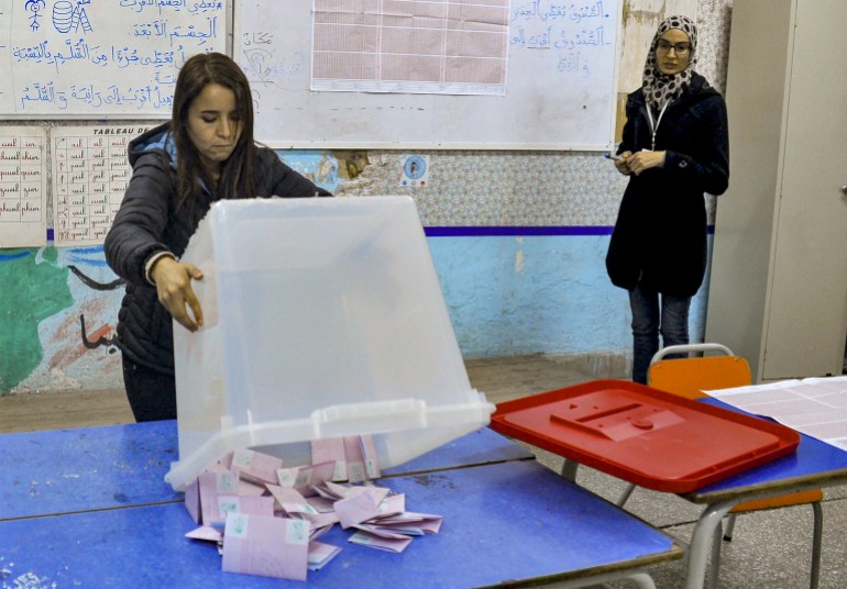 An ISIE agent begins counting ballots at a polling station in Tunis