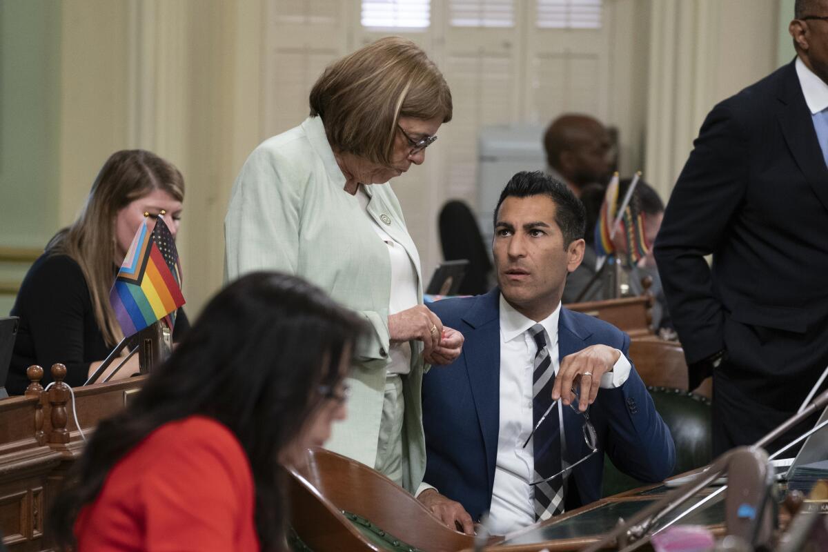 Assemblywoman Cecilia Aguilar-Curry talks with Assembly Speaker Robert Rivas inside the California Capitol