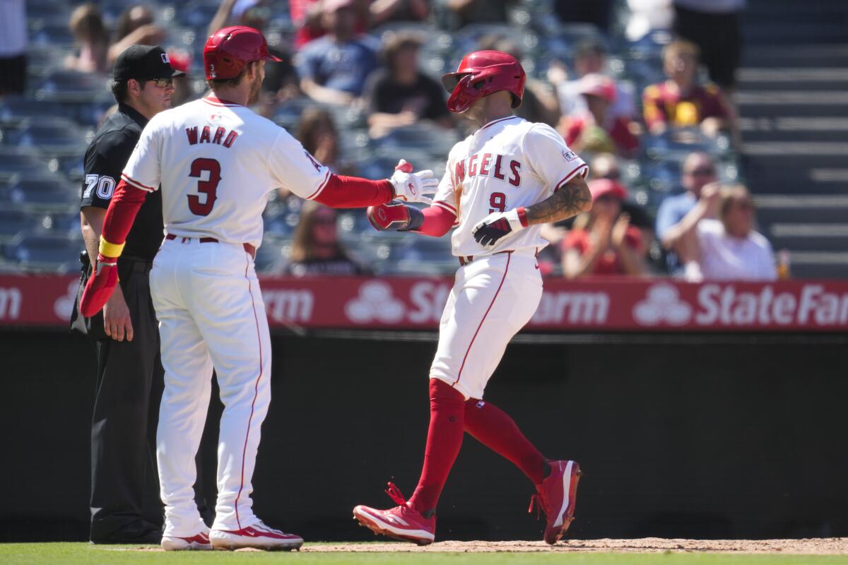 Angels teammates Taylor Ward (3) and Zach Neto (9) celebrate after scoring 