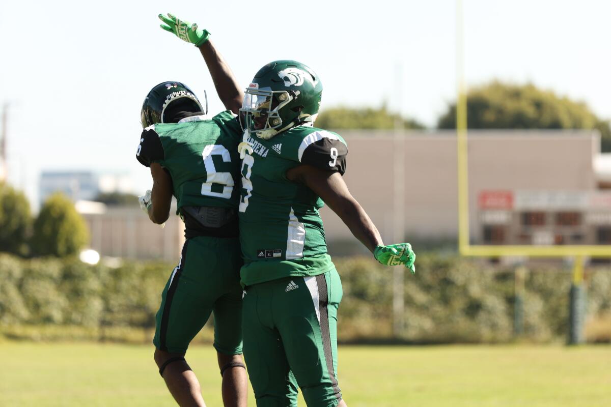 Gardena Receiver D'Maj Longley jumps in celebration with Xavier Grant after scoring a touchdown against Crenshaw.