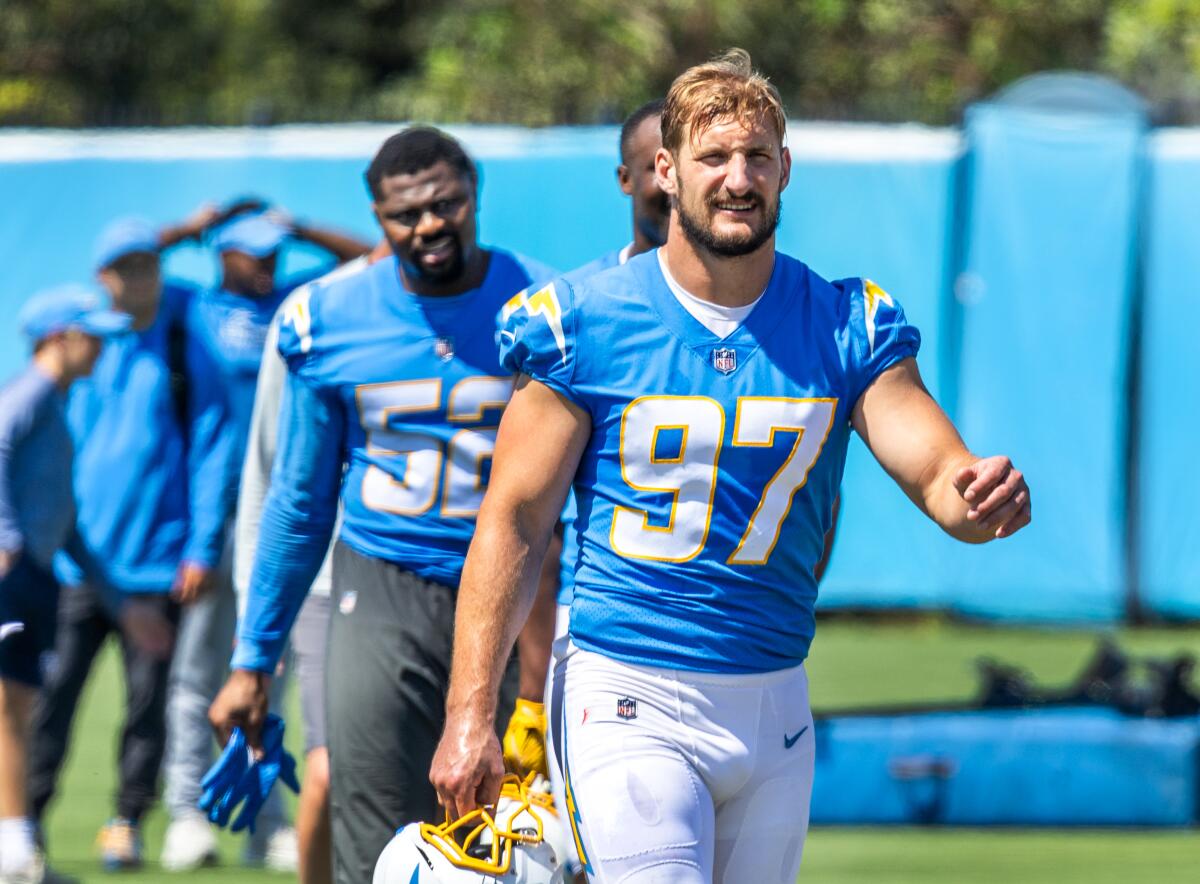 Chargers outside linebackers Khalil Mack (52) and Joey Bosa (97) walk off the field during minicamp in June.