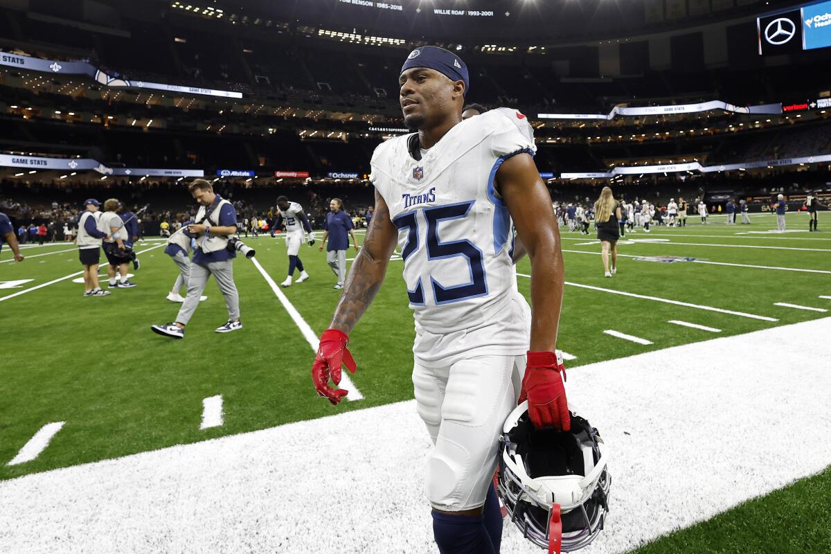 Tennessee Titans running back Hassan Haskins walks off the field after a preseason game.