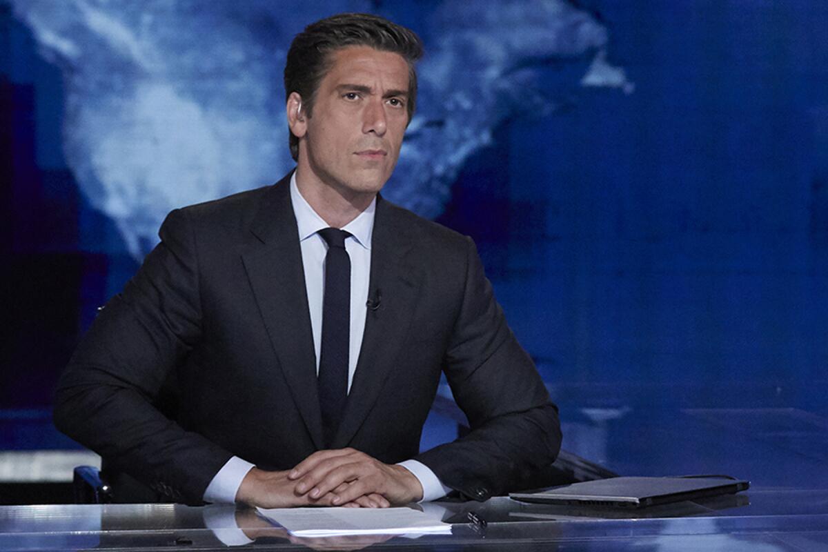 David Muir sitting at the ABC News anchor desk.