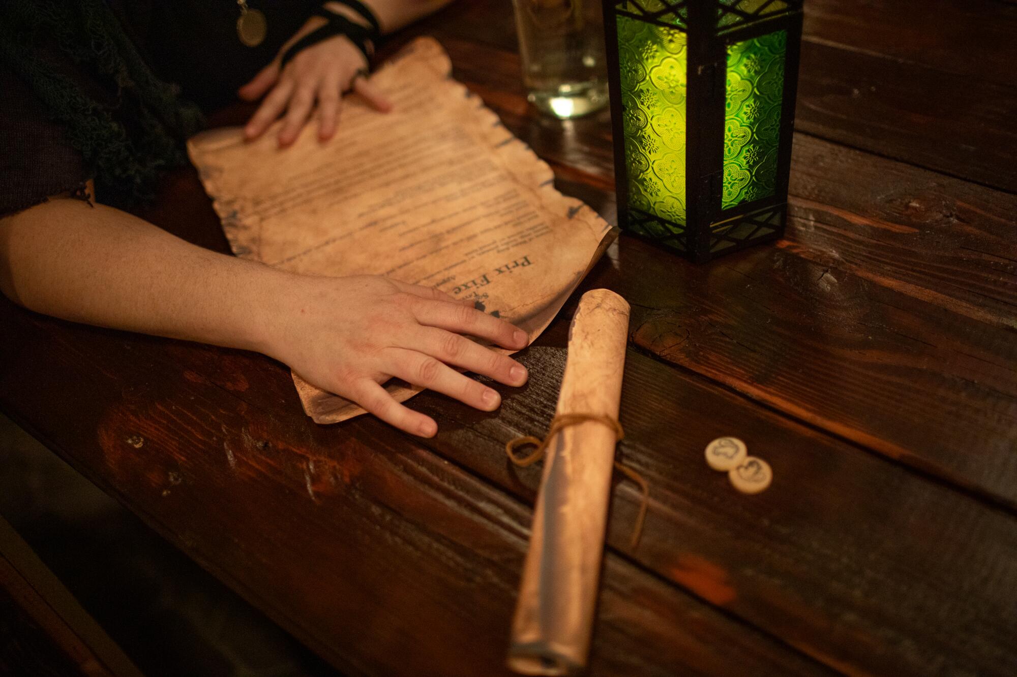 A guest unwraps a menu in a scroll at Squirrelor's Tavern. 