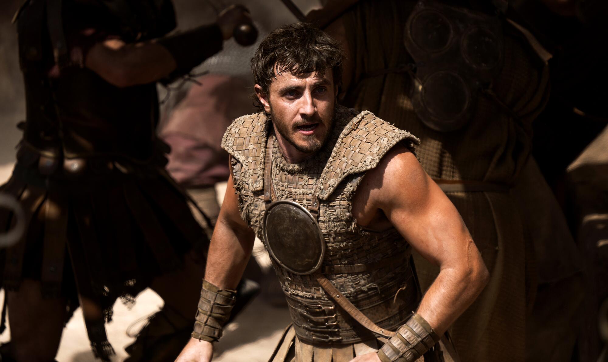 A man in gladiatorial armor charges.