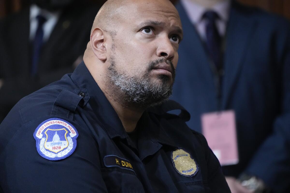 U.S. Capitol Police Sgt. Harry Dunn in uniform while listening to a hearing