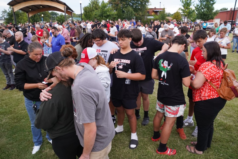 People mourn at a vigil after the shooting at Apalachee High School