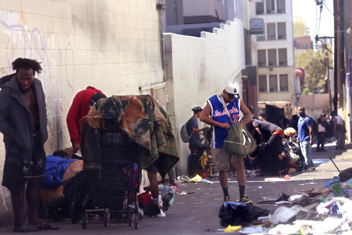 People congregate in an alley by MacArthur Park where drug use is rampant in the Westlake neighborhood 