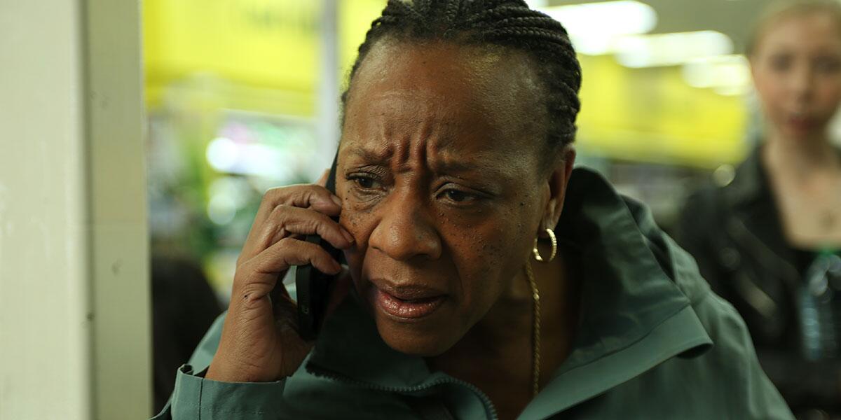 A woman talks into a cell phone.