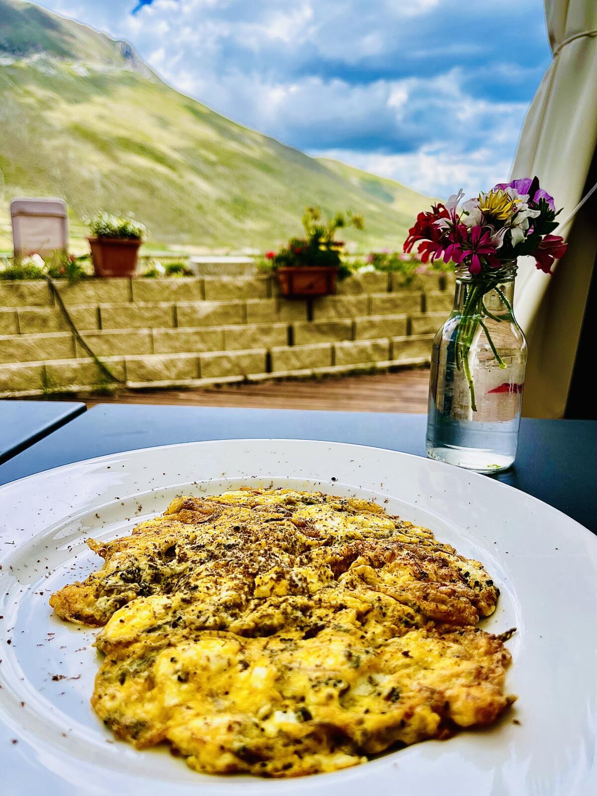 Eggs scattered with Umbrian black summer truffles at Taverna Castelluccio in the Italian town of Castelluccio.