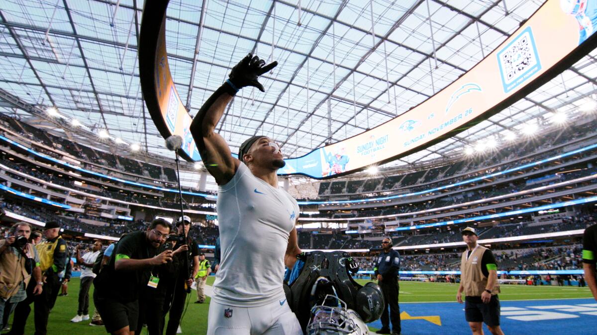 A football player gazes up at the stadium crowd