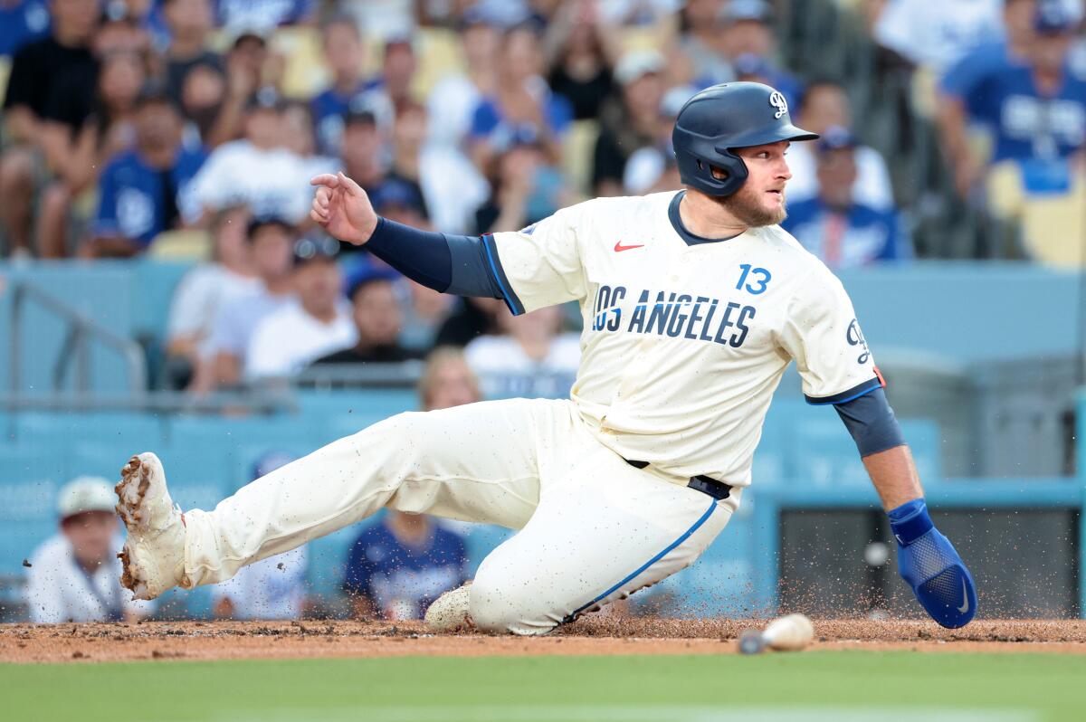 Max Muncy scores a run against the Guardians in the first inning Saturday.