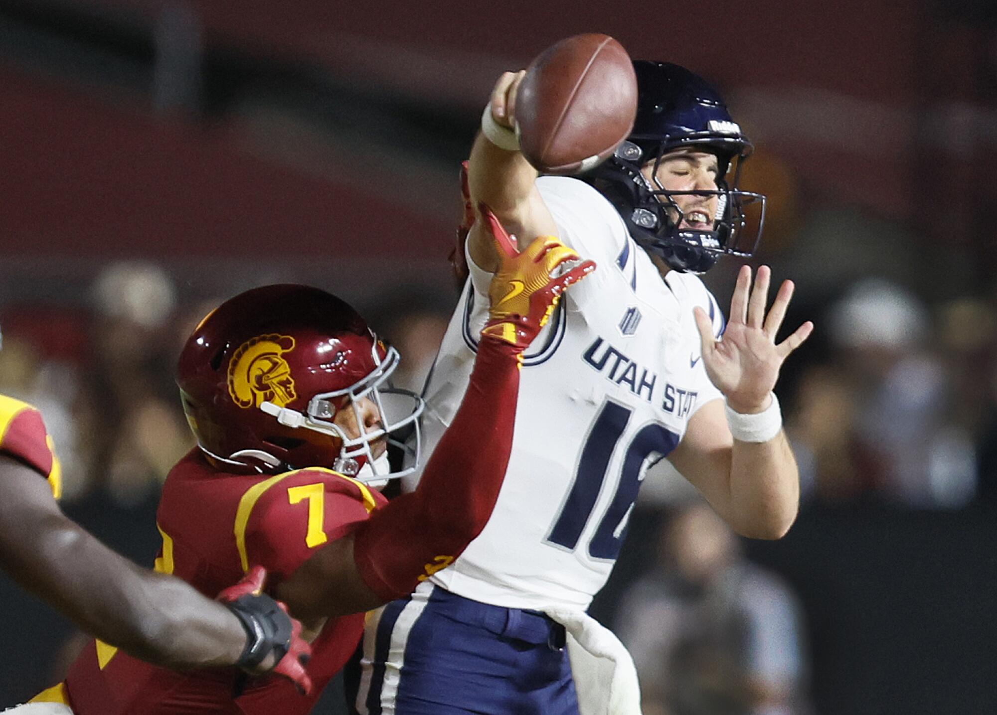 USC safety Kamari Ramsey knocks the ball out of the hands of Utah State quarterback Bryson Barnes.