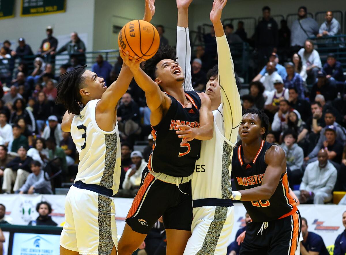 Brayden Burries of Eastvale Roosevelt goes up for shot against St. John Bosco's Elzie Harrington (3).