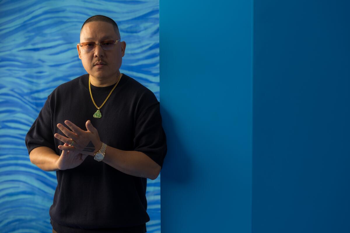 "Vice Is Broke" filmmaker Eddie Huang in a black T-shirt in front of a blue background.