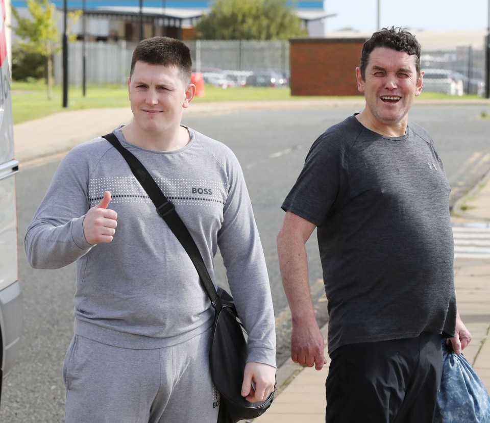 Christopher Hope gives a thumbs up on his release with a fellow inmate