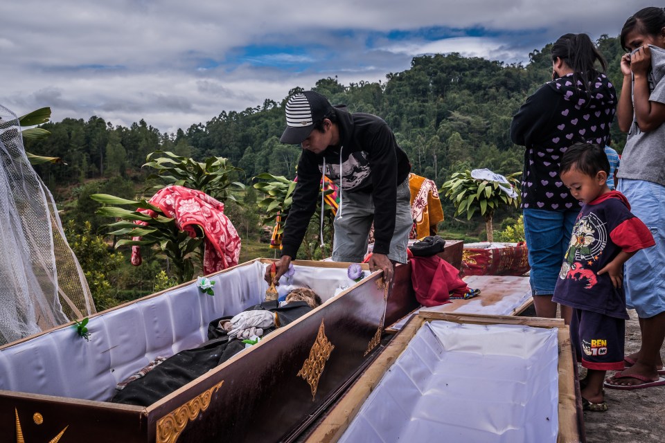 The bodies are kept in coffins in the side of cliffs in between ceremonies