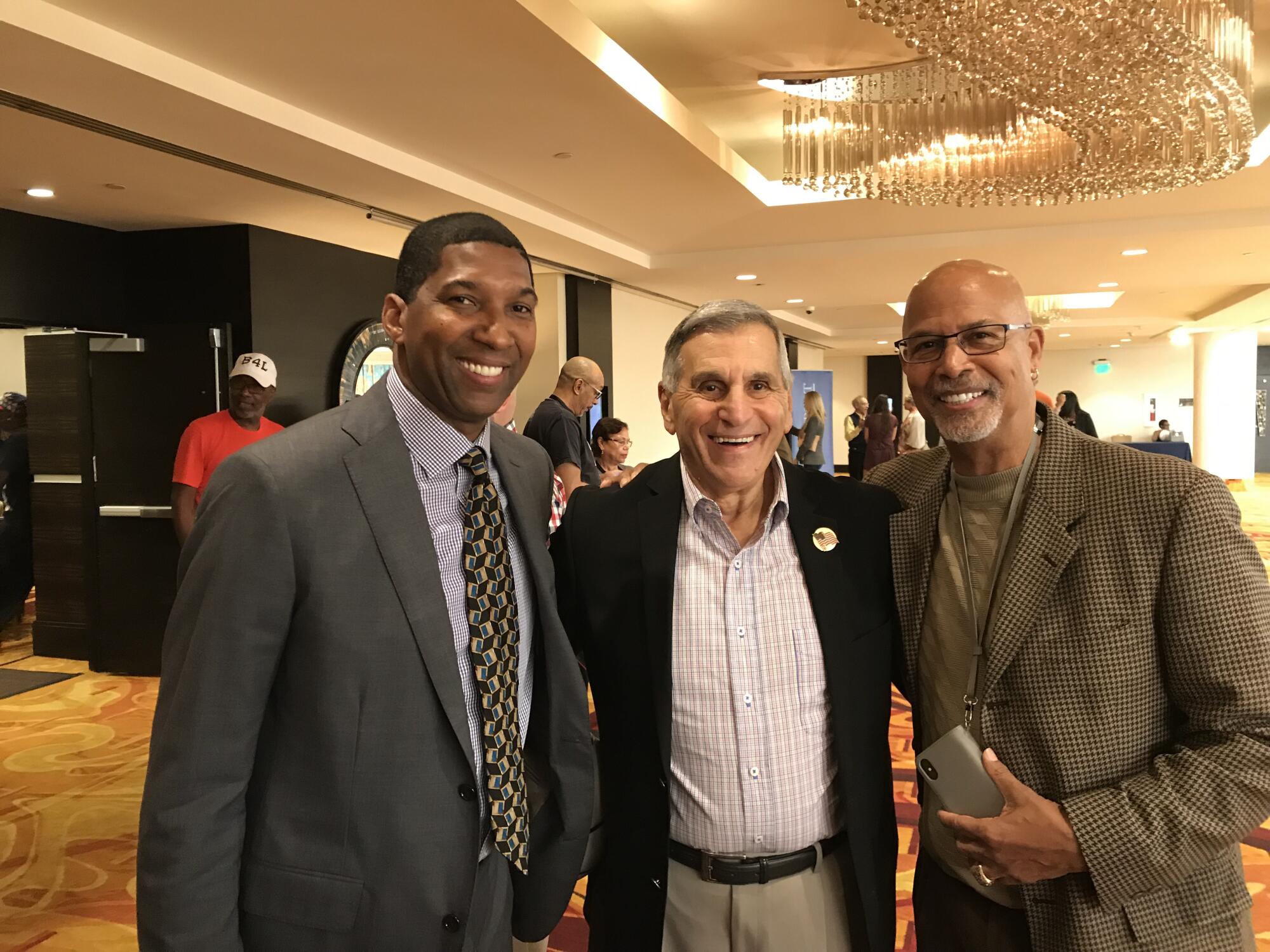 Rod Foster, left, stands with UCLA coaching legend Jim Harrick and former UCLA basketball standout Mike Warren.