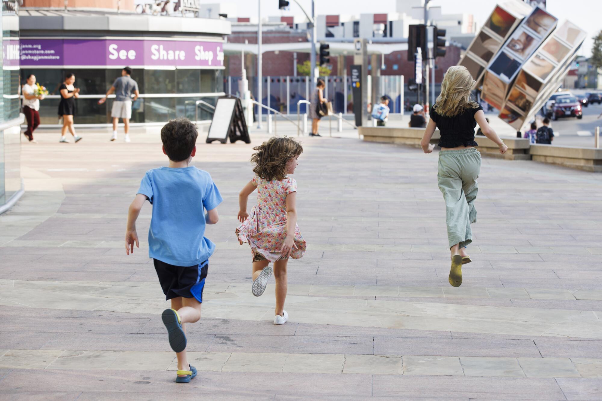 The Moran children race between locations while playing "Spies Among Us" in Little Tokyo.