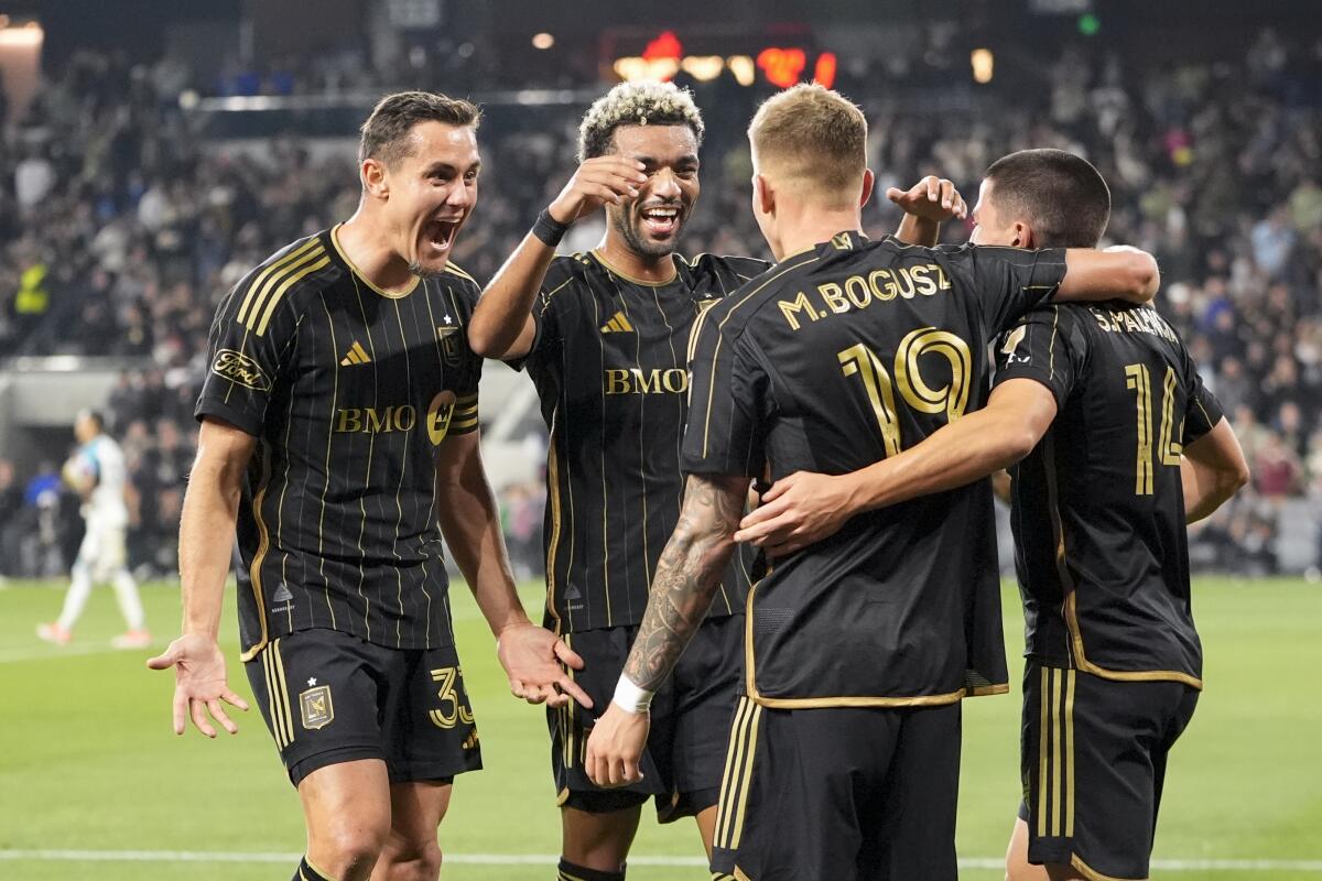 LAFC midfielder Mateusz Bogusz celebrates with defender Aaron Long, midfielder Timothy Tillman and defender Sergi Palencia.