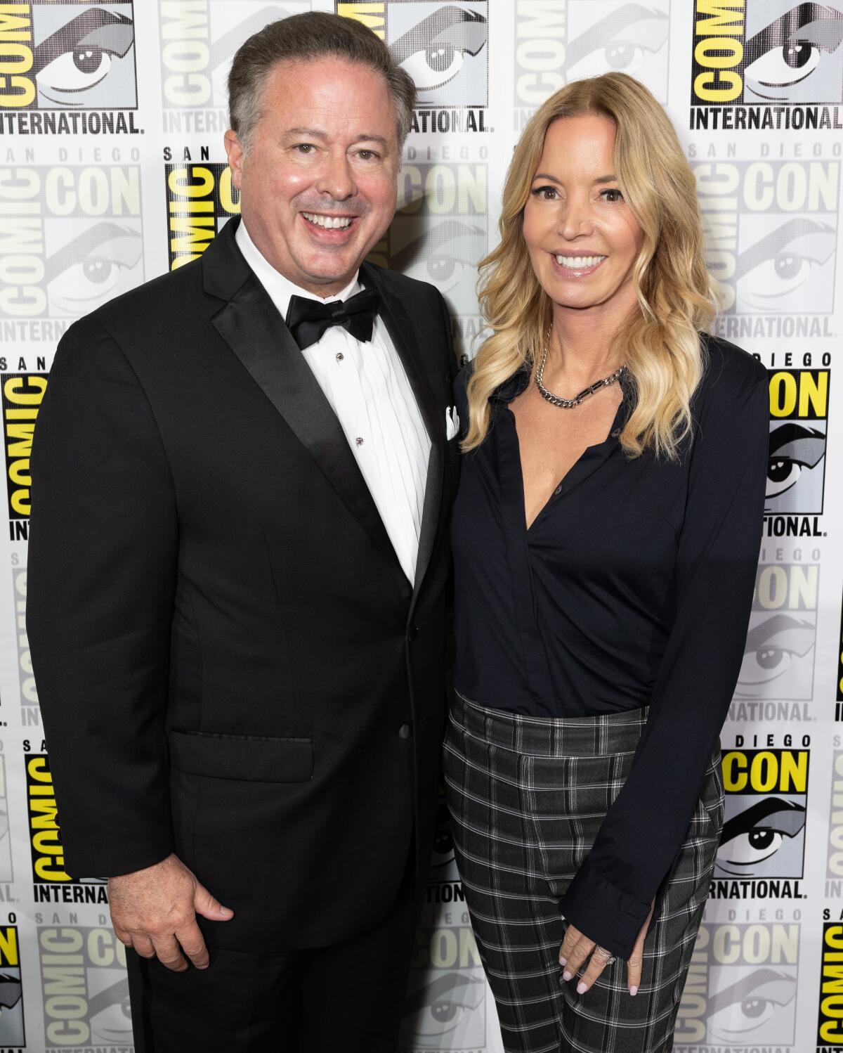 Women of Wrestling co-owners David McLane and Jeanie Buss pose for photos at San Diego Comic-Con