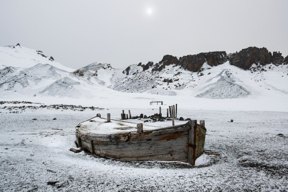 A wooden boat hull beached on Deception island