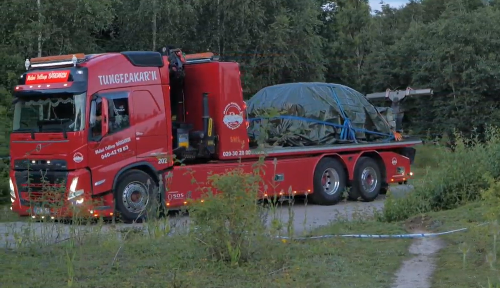 The wrecked car is taken away as police continue to investigate