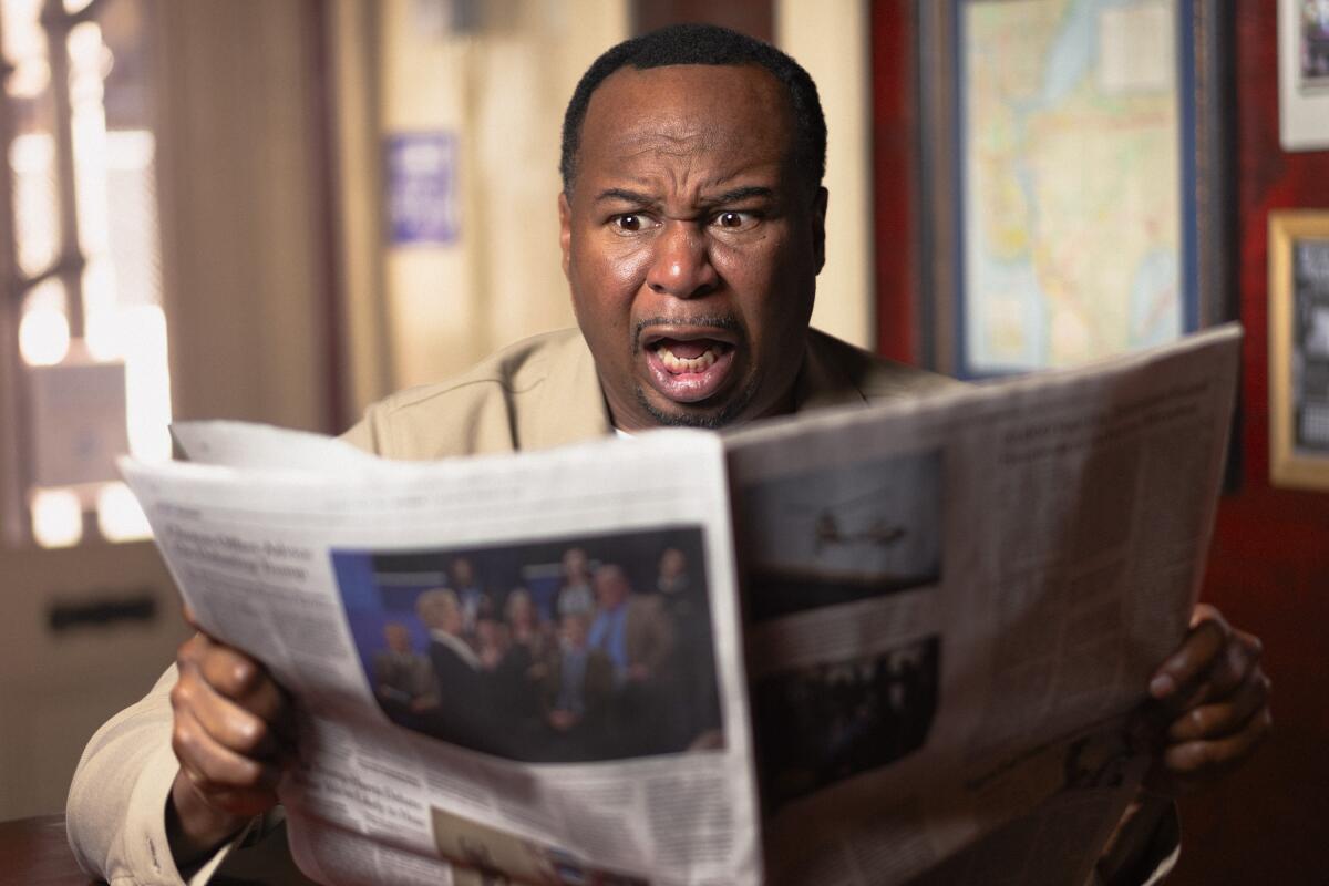 A man holding a newspaper with his mouth open.