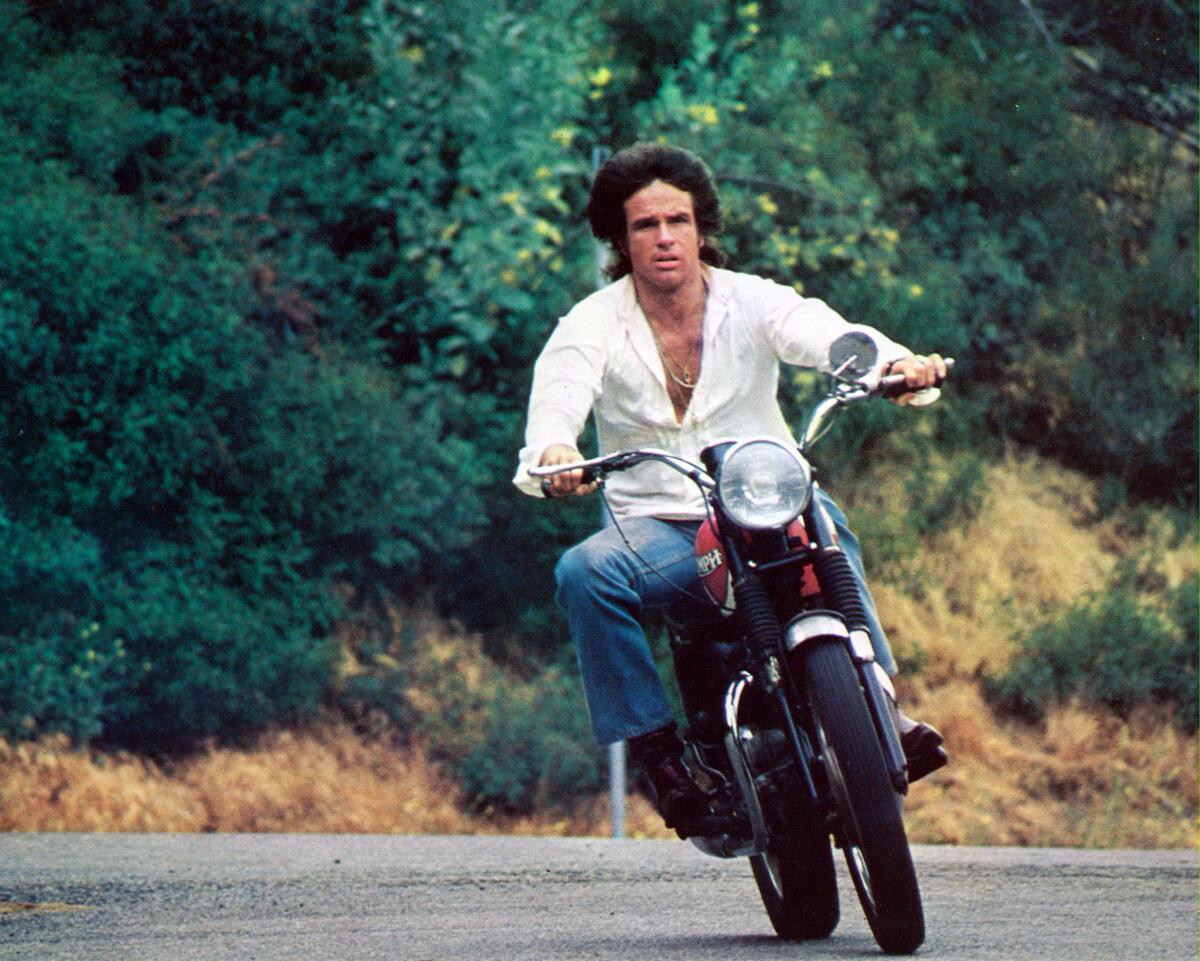 A man rides on a motorcycle in Los Angeles.