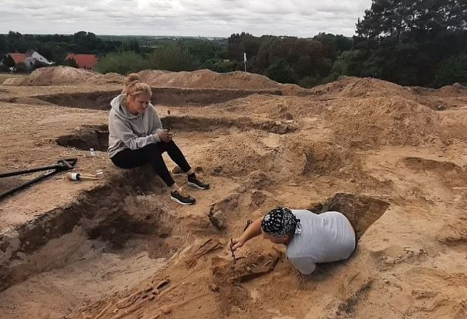 Archaeologists uncovering several skeletons in Pien, Poland, September 2023