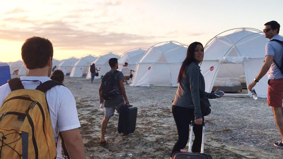 Instead of luxury beach huts, they saw white-domed tents of the type used for displaced hurricane victims