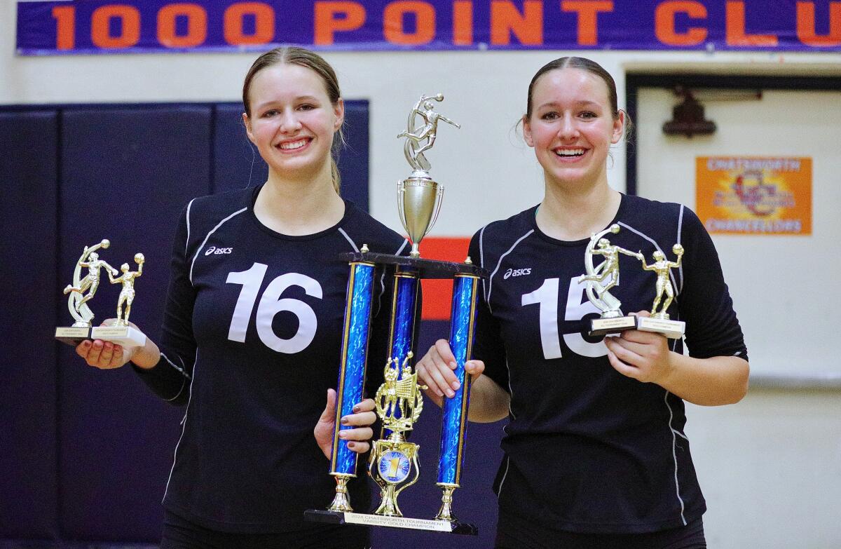 Thousand Oaks sisters London, left, and Saylor Halvorsen hold the championship trophy and all-tournament awards